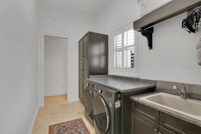 an aerial view of a house with a garden and trees