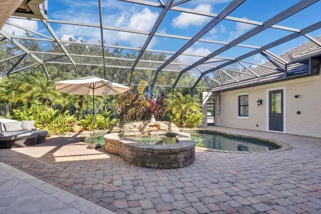 an aerial view of house with yard and lake view