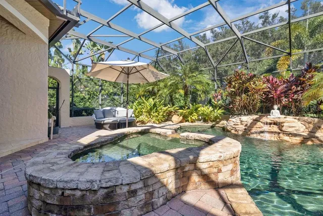 an aerial view of a house with outdoor space swimming pool and lake view