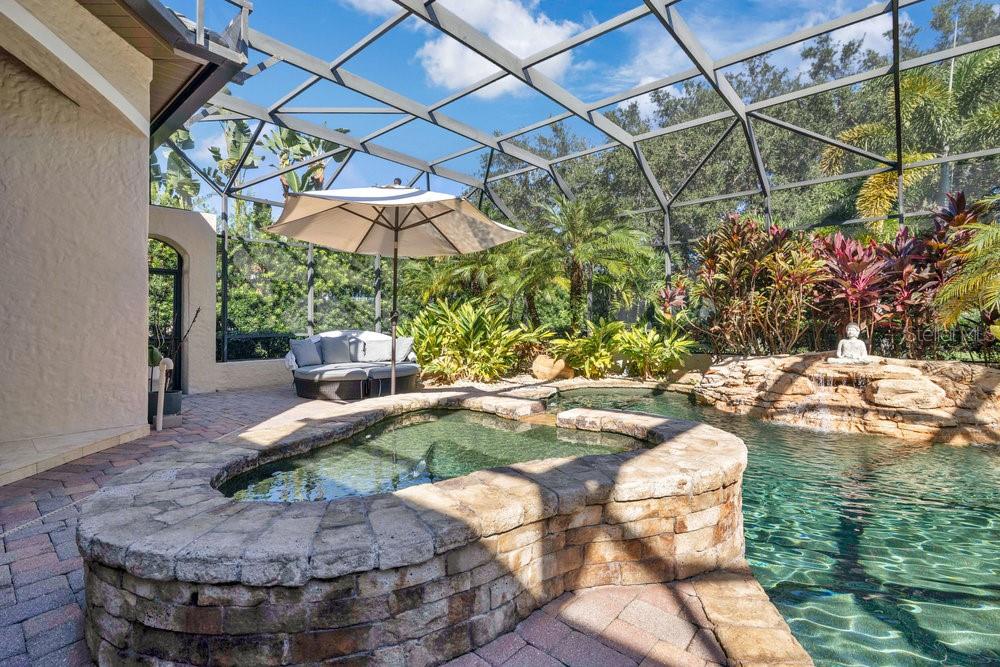 9204 Tibet Pointe Circle Windermere, FL 34786 - Photo 49 of 72 a view of a backyard with table and chairs under an umbrella