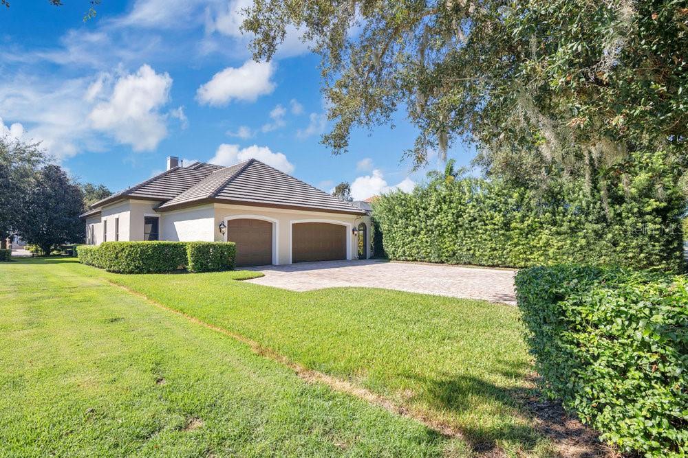 9204 Tibet Pointe Circle Windermere, FL 34786 - Photo 53 of 72 a front view of a house with yard and green space