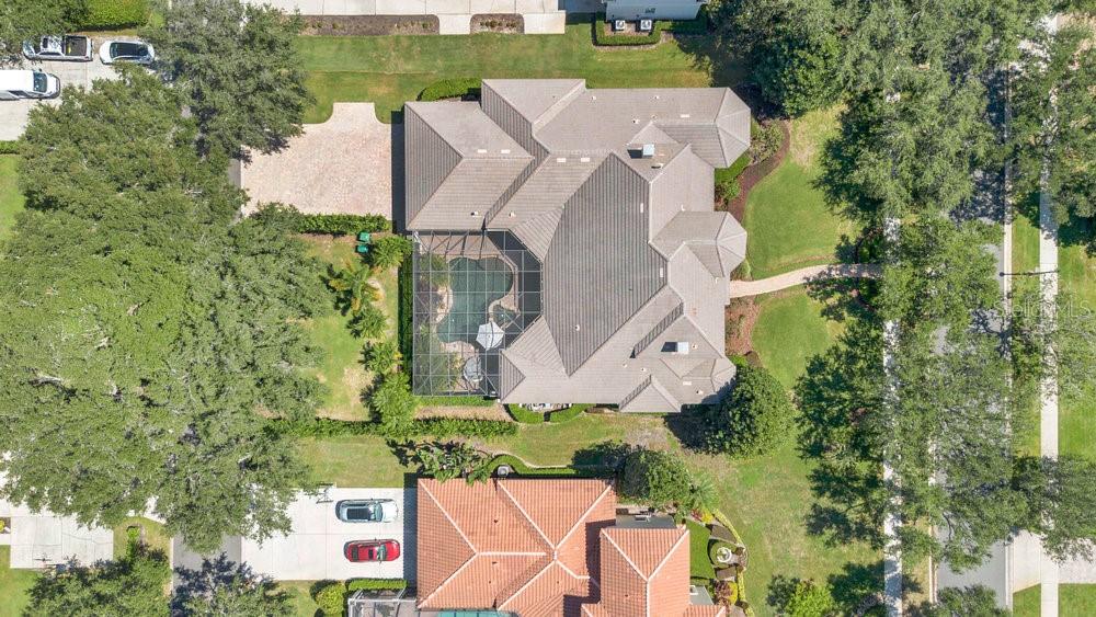 9204 Tibet Pointe Circle Windermere, FL 34786 - Photo 60 of 72 an aerial view of a house with a garden and trees