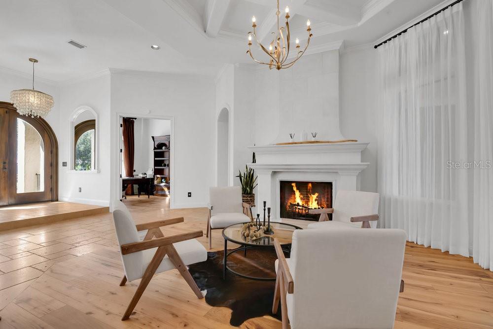 9204 Tibet Pointe Circle Windermere, FL 34786 - Photo 6 of 72 a living room with furniture a fireplace and a chandelier