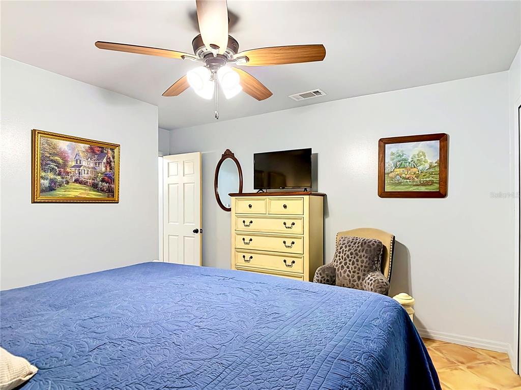 1395 Maytown Road Osteen, FL 32764 - Photo 33 of 65 a bedroom with a bed and a flat screen tv