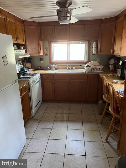 37686 Holly Street Ocean View, DE 19970 - Photo 2 of 10 a kitchen with a sink a stove a microwave and cabinets