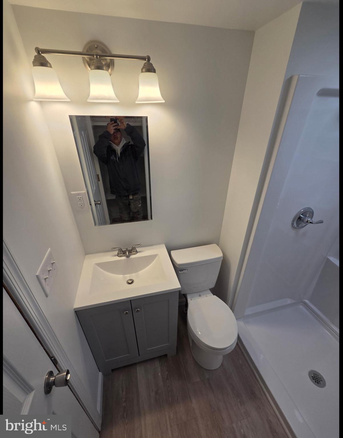 37686 Holly Street Ocean View, DE 19970 - Photo 8 of 10 a bathroom with a sink mirror vanity and toilet