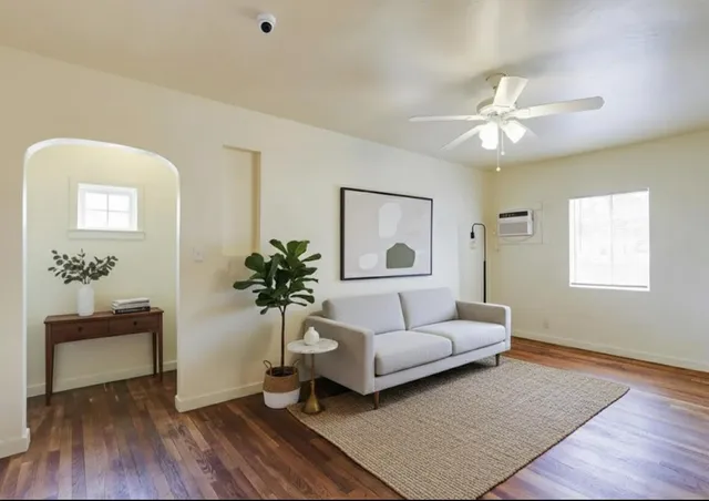a living room with furniture and a potted plant