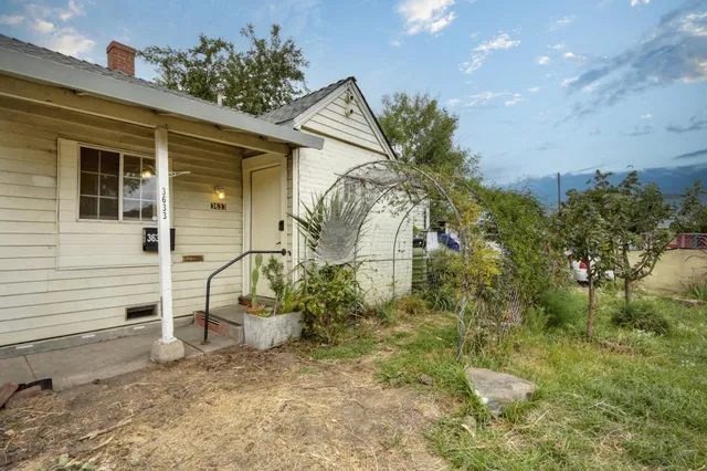 a view of a house with a backyard and sitting area