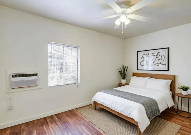 a bedroom with a large bed and a chandelier