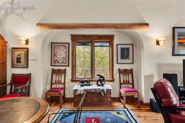 a living room with furniture and a floor to ceiling window