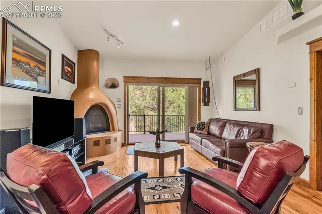a living room with furniture a fireplace and a large window