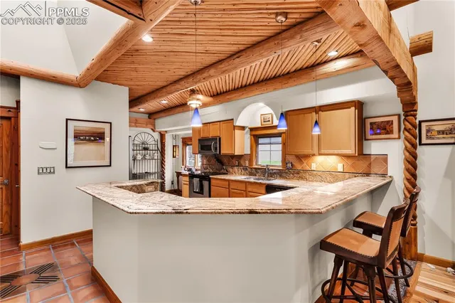 a kitchen with a table and chairs