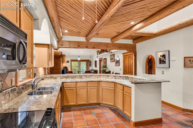 a kitchen with a sink a counter space cabinets and appliances
