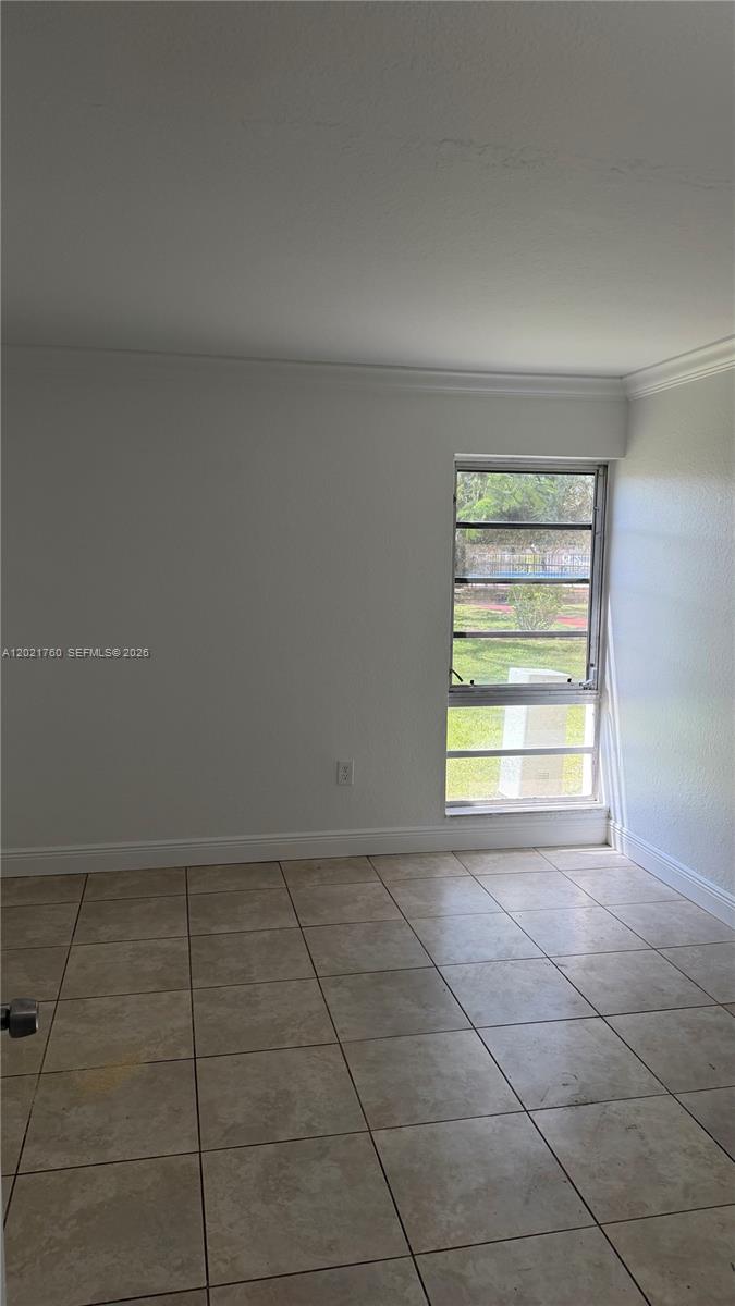 3901 Southwest 109th Avenue, Unit 4 Miami, FL 33165 - Photo 14 of 15 a view of an empty room with a window