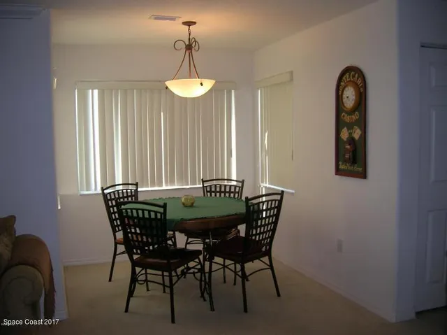 a view of a dining room with furniture and window