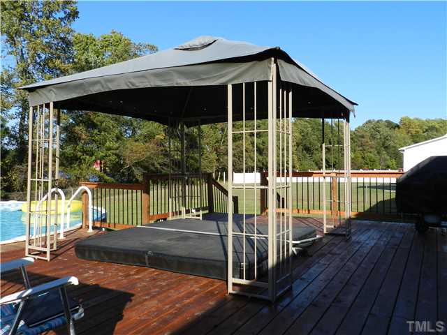 174 Roping Horn Way Willow Spring, NC 27592 - Photo 14 of 15 a view of a deck with a floor to ceiling window and wooden fence