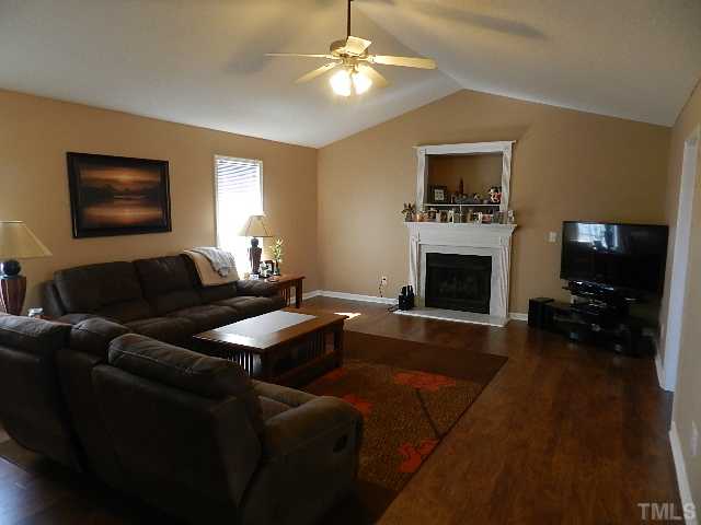 174 Roping Horn Way Willow Spring, NC 27592 - Photo 2 of 15 a living room with furniture flat screen tv and a fireplace
