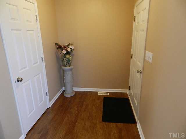 174 Roping Horn Way Willow Spring, NC 27592 - Photo 4 of 15 a view of a hallway with wooden floor and staircase