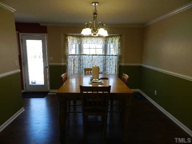 174 Roping Horn Way Willow Spring, NC 27592 - Photo 5 of 15 a dining room with a table chairs and a chandelier