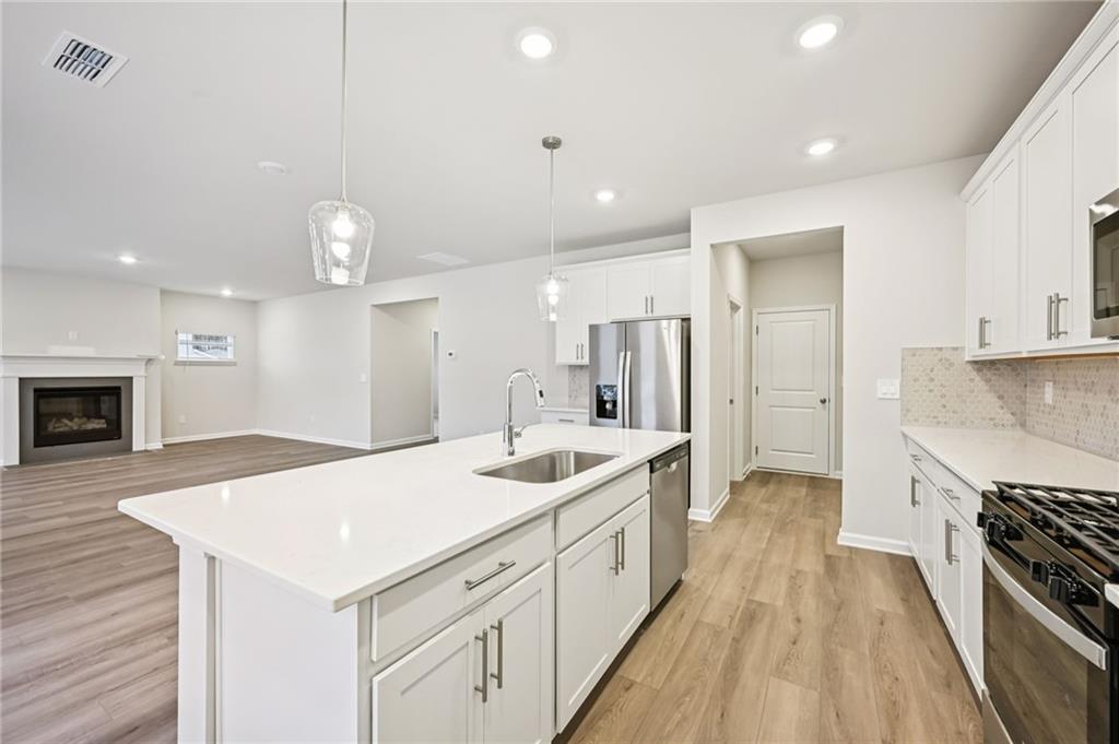 1408 High Fls Lane Grayson, GA 30017 - Photo 16 of 48 a large kitchen with kitchen island a sink stainless steel appliances and cabinets