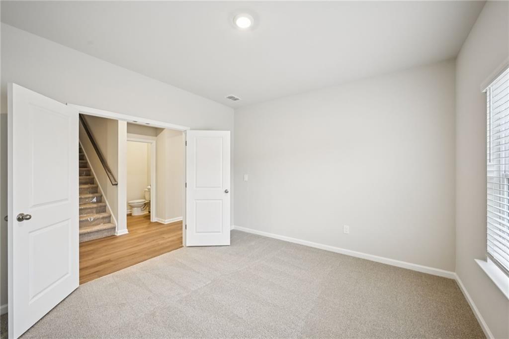 1408 High Fls Lane Grayson, GA 30017 - Photo 18 of 48 an empty room with a staircase