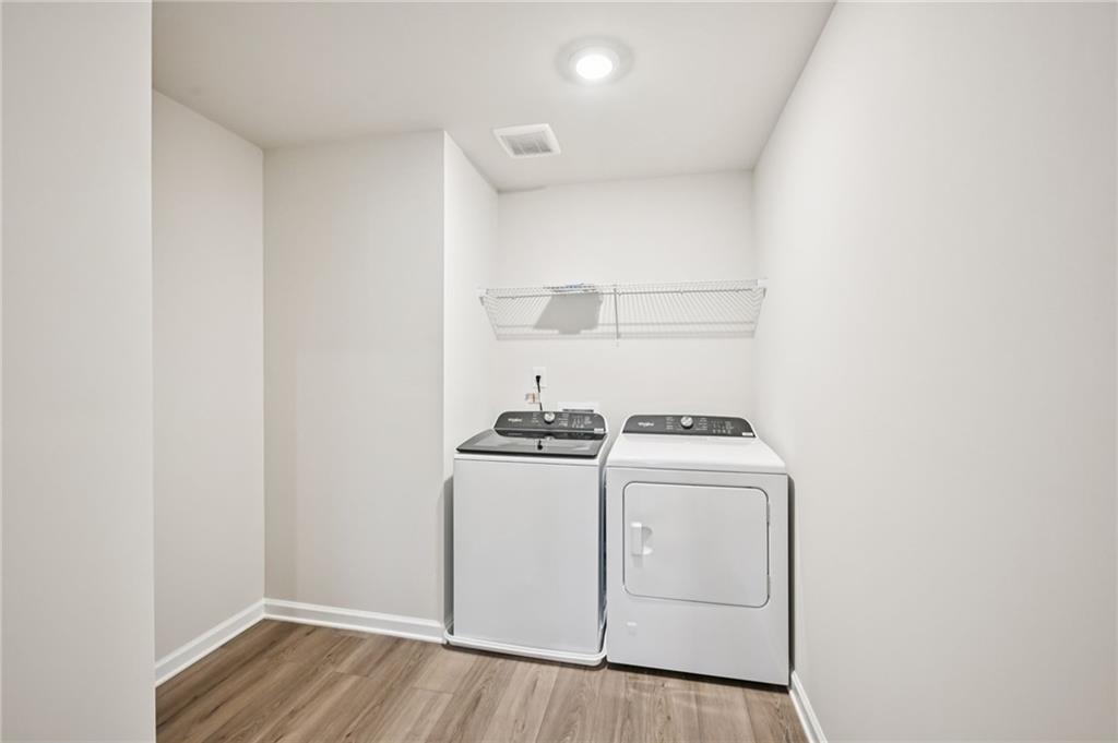 1408 High Fls Lane Grayson, GA 30017 - Photo 28 of 48 a view of a kitchen with stove and wooden floor