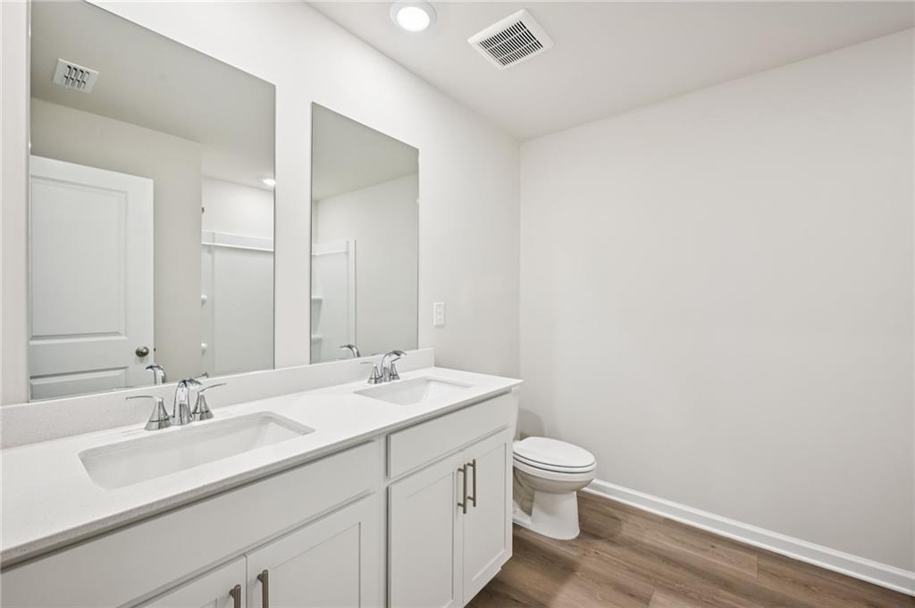1408 High Fls Lane Grayson, GA 30017 - Photo 31 of 48 a bathroom with a granite countertop sink a toilet and a mirror