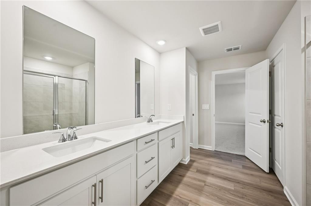 1408 High Fls Lane Grayson, GA 30017 - Photo 43 of 48 a bathroom with double vanity sinks and a mirror
