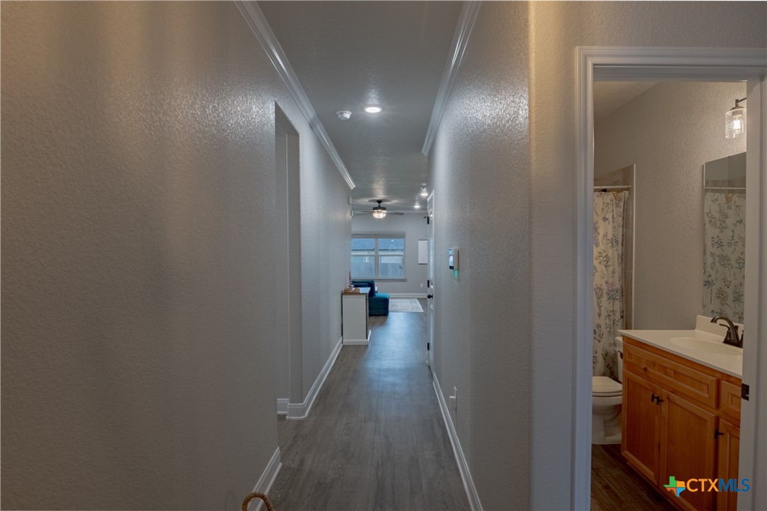7909 McCulloch Road Temple, TX 76502 - Photo 3 of 46 a view of a hallway and a livingroom with wooden floor