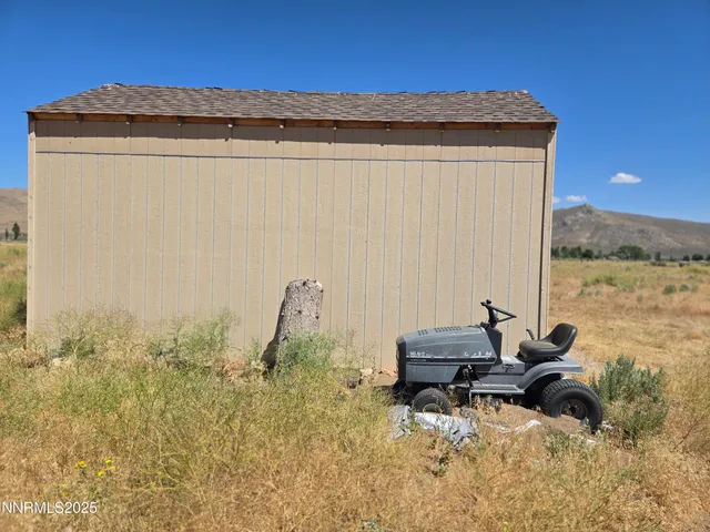 a backyard of a house with table and chairs