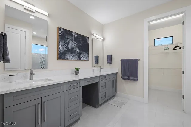 a bathroom with a double vanity sink mirror and bathtub