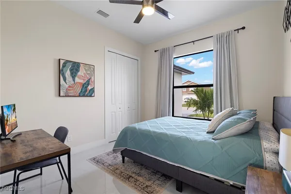 a bedroom with a bed window and a desk