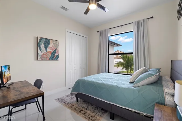 a bedroom with a bed window and a desk