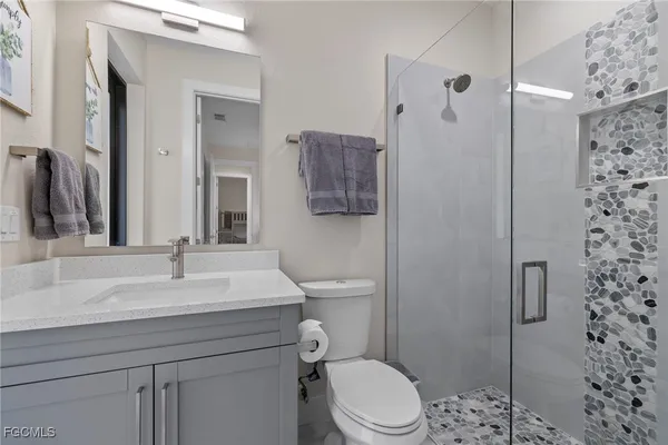 a bathroom with a sink toilet and shower
