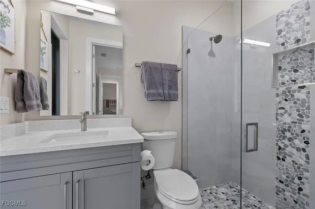 a bathroom with a sink toilet and shower