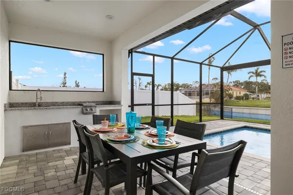 a view of a dining room with furniture large windows and wooden floor