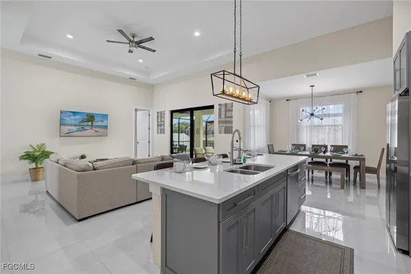 a view of living room kitchen island with furniture and chandelier