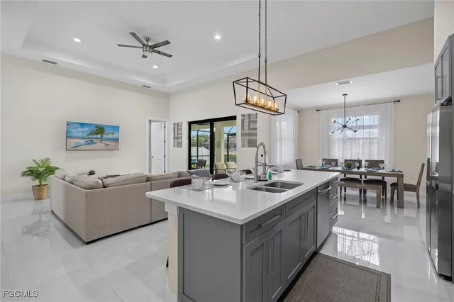 a view of living room kitchen island with furniture and chandelier
