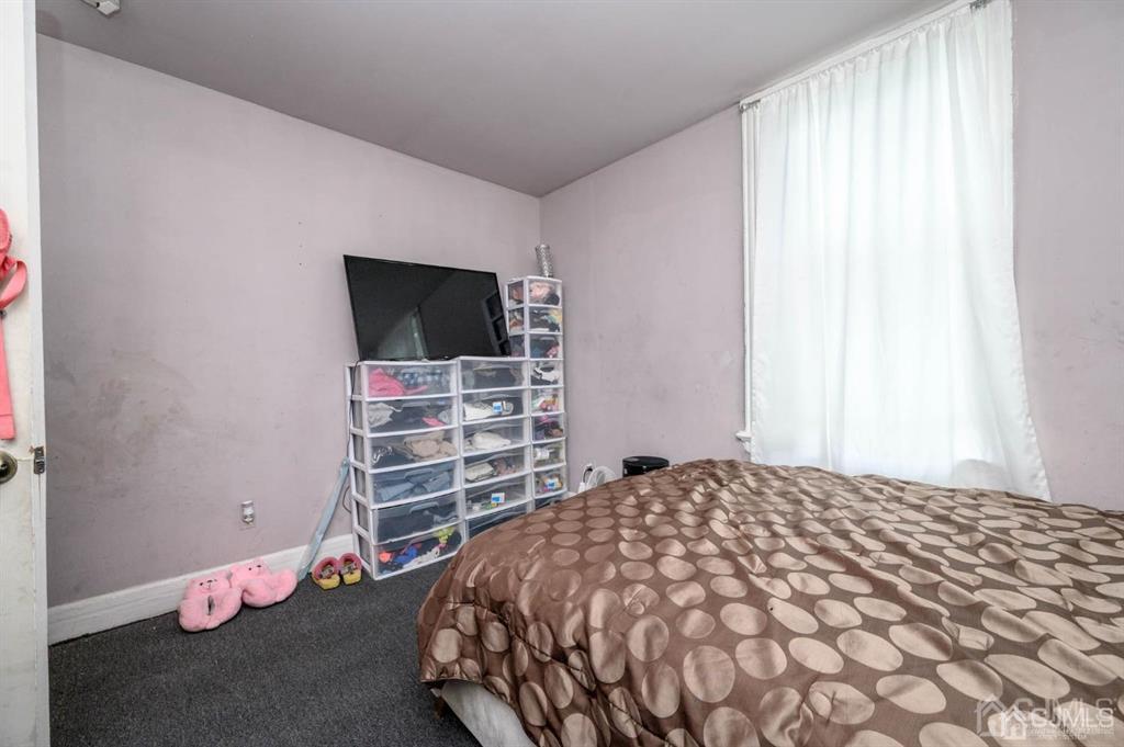 8 Ricord Street Newark, NJ 07106 - Photo 17 of 39 a bedroom with a bed and a flat screen tv