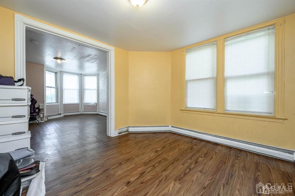 8 Ricord Street Newark, NJ 07106 - Photo 8 of 39 an empty room with wooden floor and windows