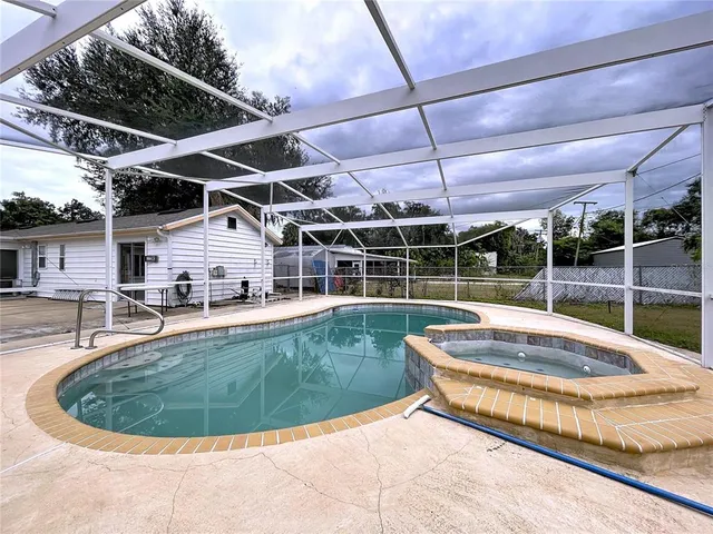a view of a swimming pool with a patio