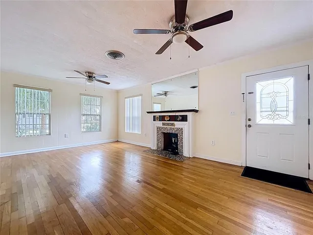 wooden floor in an empty room with a window