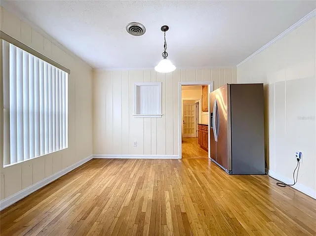 a kitchen with stainless steel appliances granite countertop a stove cabinets and wooden floor