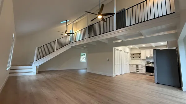 a view of entryway and kitchen with wooden floor