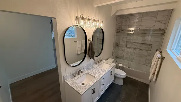 a bathroom with a sink mirror and shower