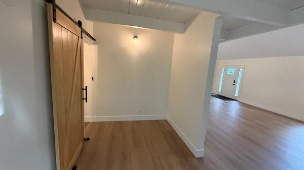 a view of hallway with wooden floor