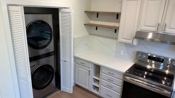 a kitchen with a stove and a refrigerator
