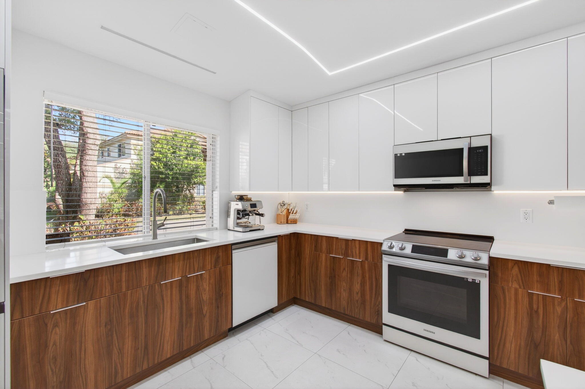 6766 Via Regina Boca Raton, FL 33433 - Photo 15 of 57 a kitchen with stainless steel appliances a stove sink and microwave