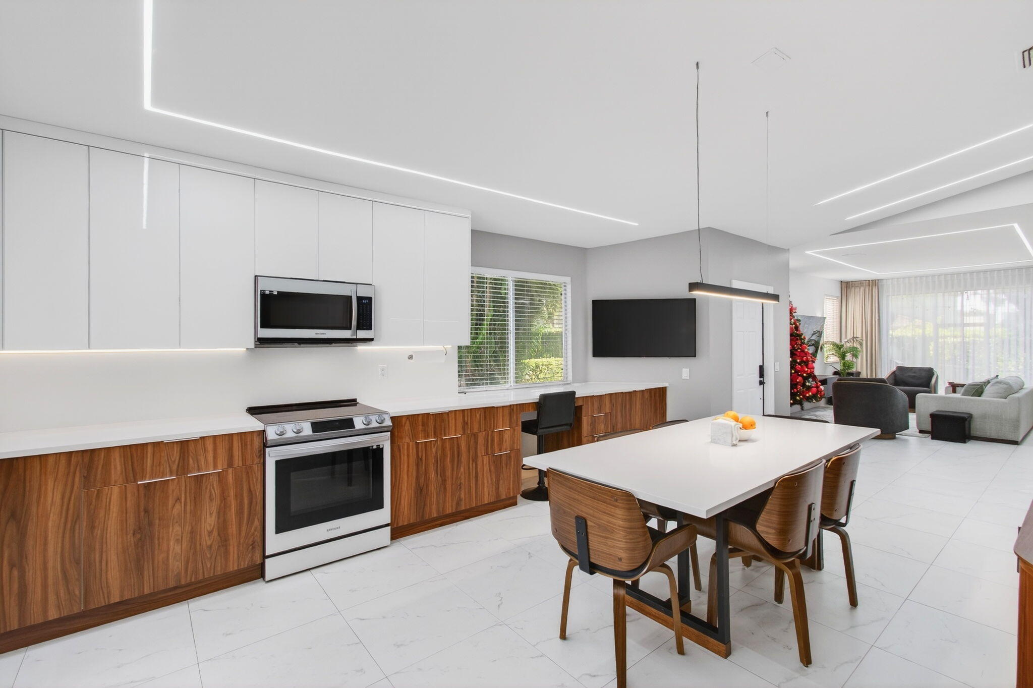 6766 Via Regina Boca Raton, FL 33433 - Photo 16 of 57 a open kitchen with stainless steel appliances granite countertop a stove a sink dishwasher a dining table and chairs with wooden floor