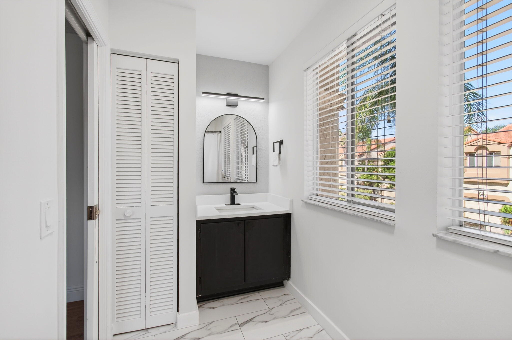 6766 Via Regina Boca Raton, FL 33433 - Photo 26 of 57 a bathroom with a sink and a mirror